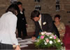 Paco signs the wedding certificate